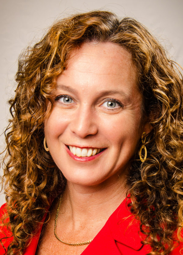 Picture of a woman with curly hair smiling